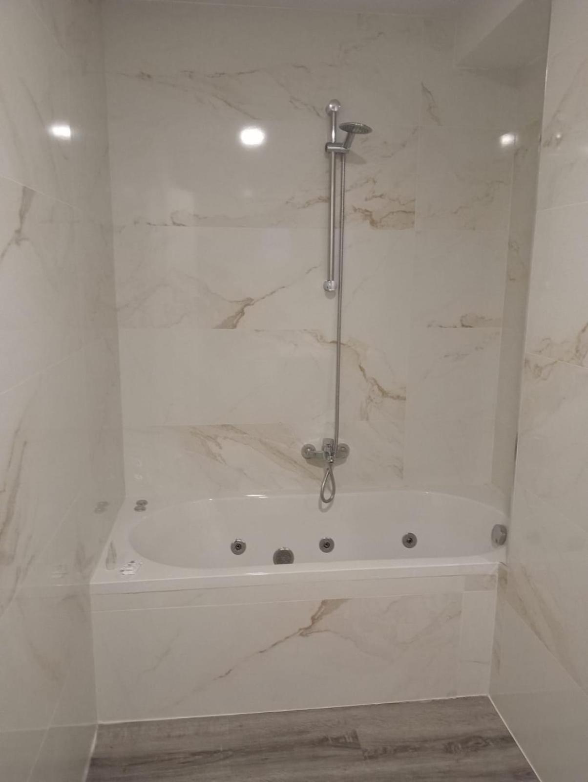 Habitación con cama grande y bañera de hidromasaje